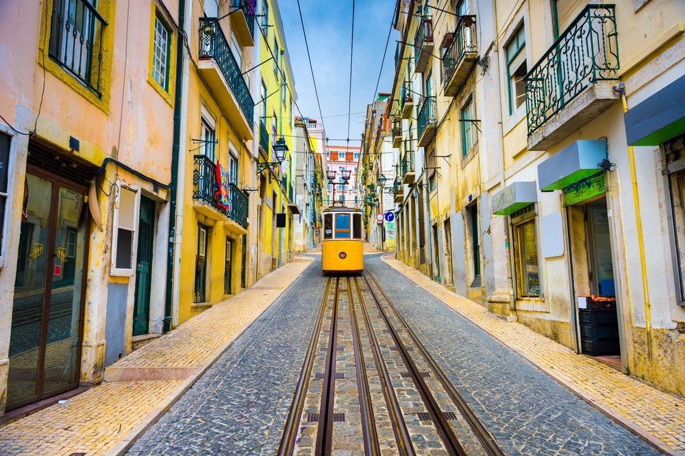 Lisbon, Portugal old town streets and tram.