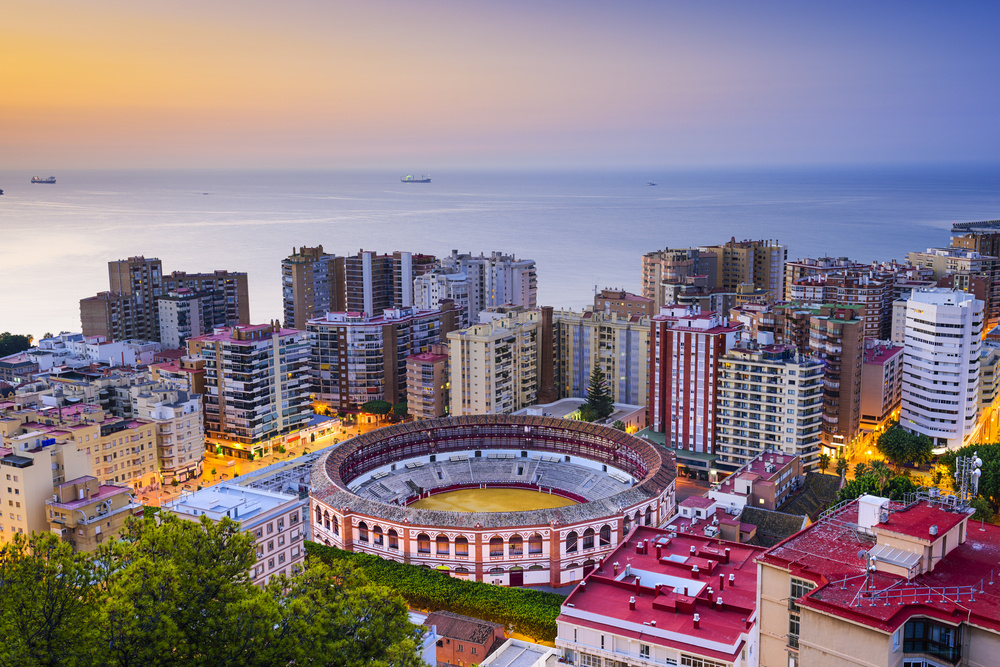 Malaga, Spain cityscape at dawn.